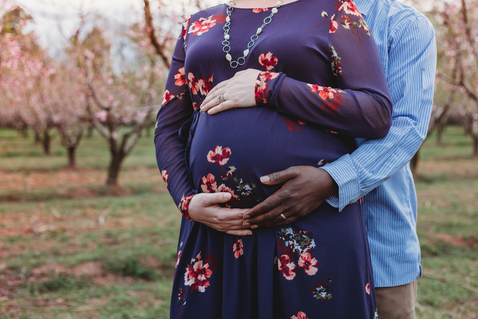close up of biracial pregnant couple maternity photos