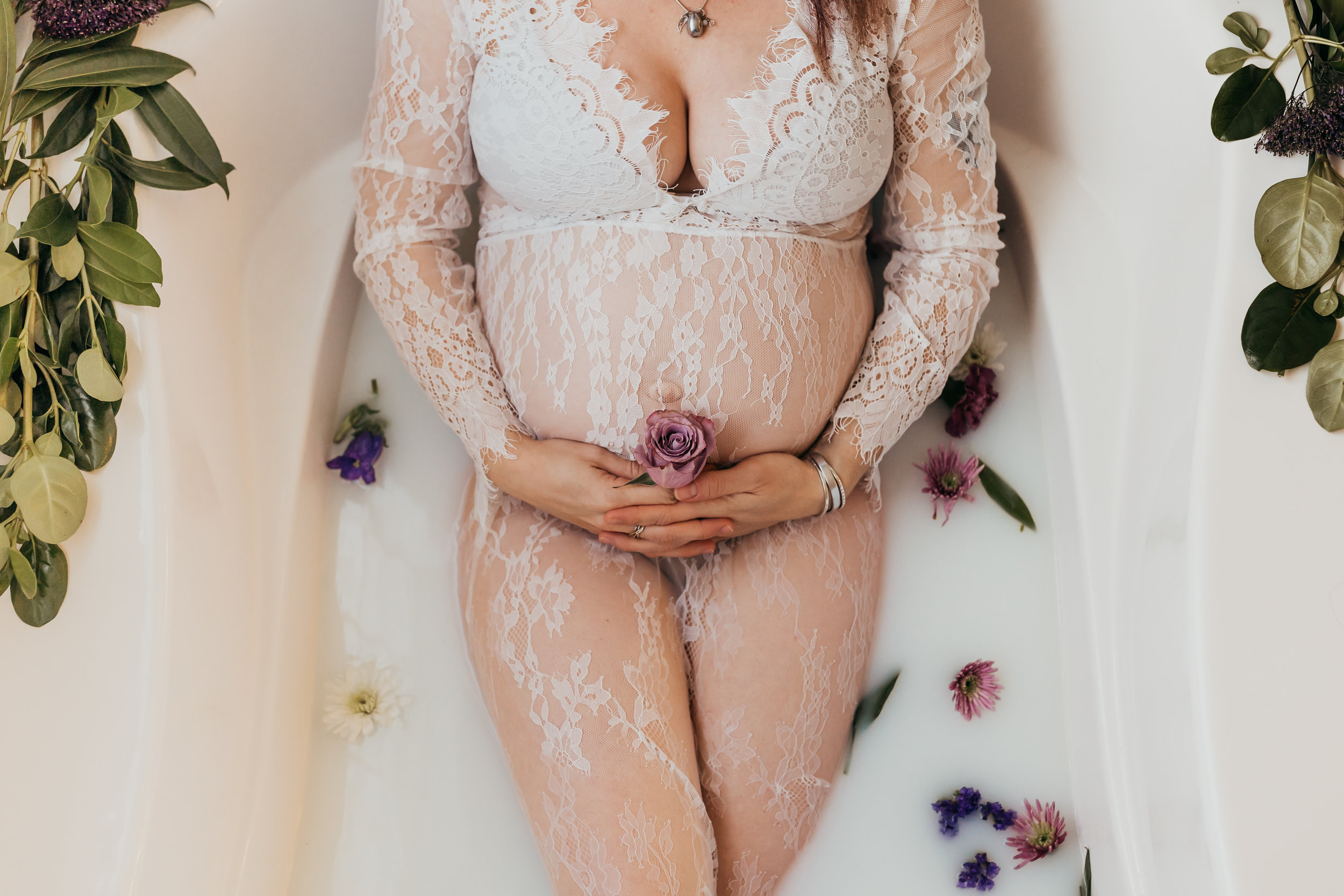 woman holding flower during milk bath