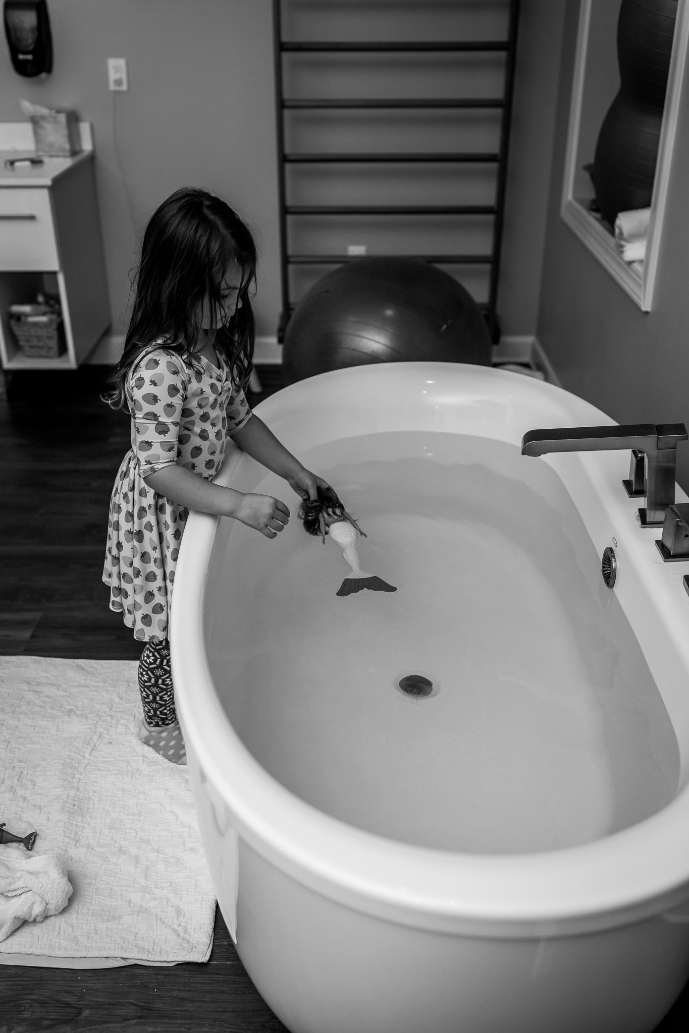 daughter plays with toy in birth center tub