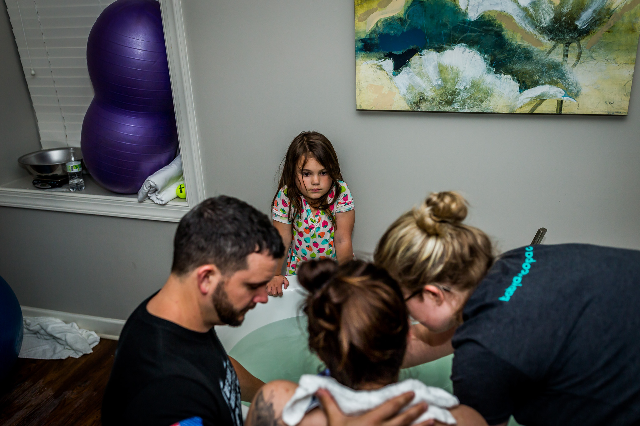 daughter watches on as mom cries in labor