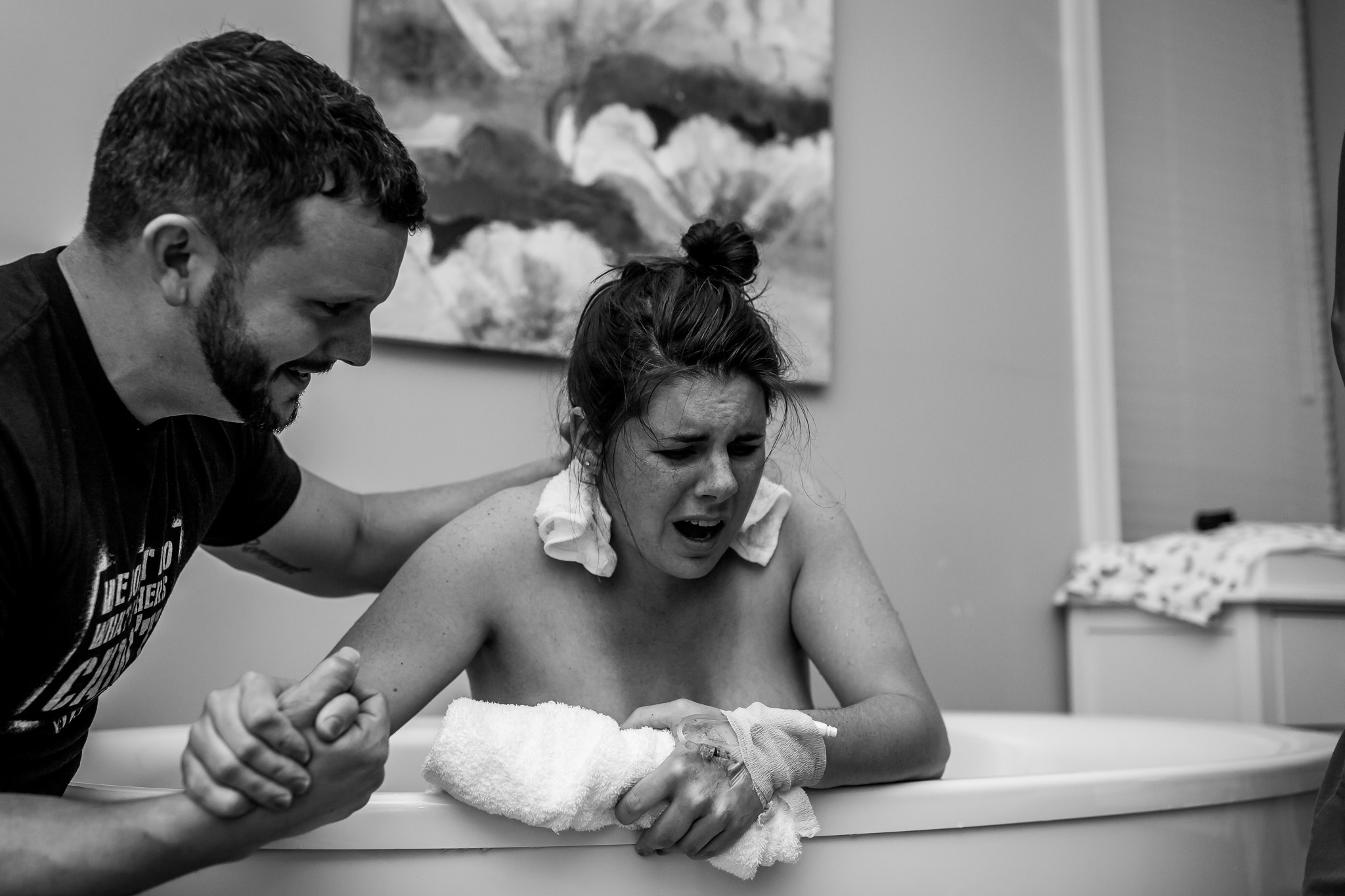 woman screams out in pain in birth tub