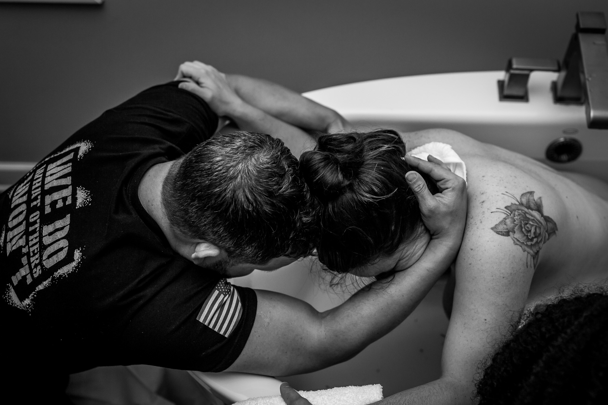 husband wife embrace in birth tub
