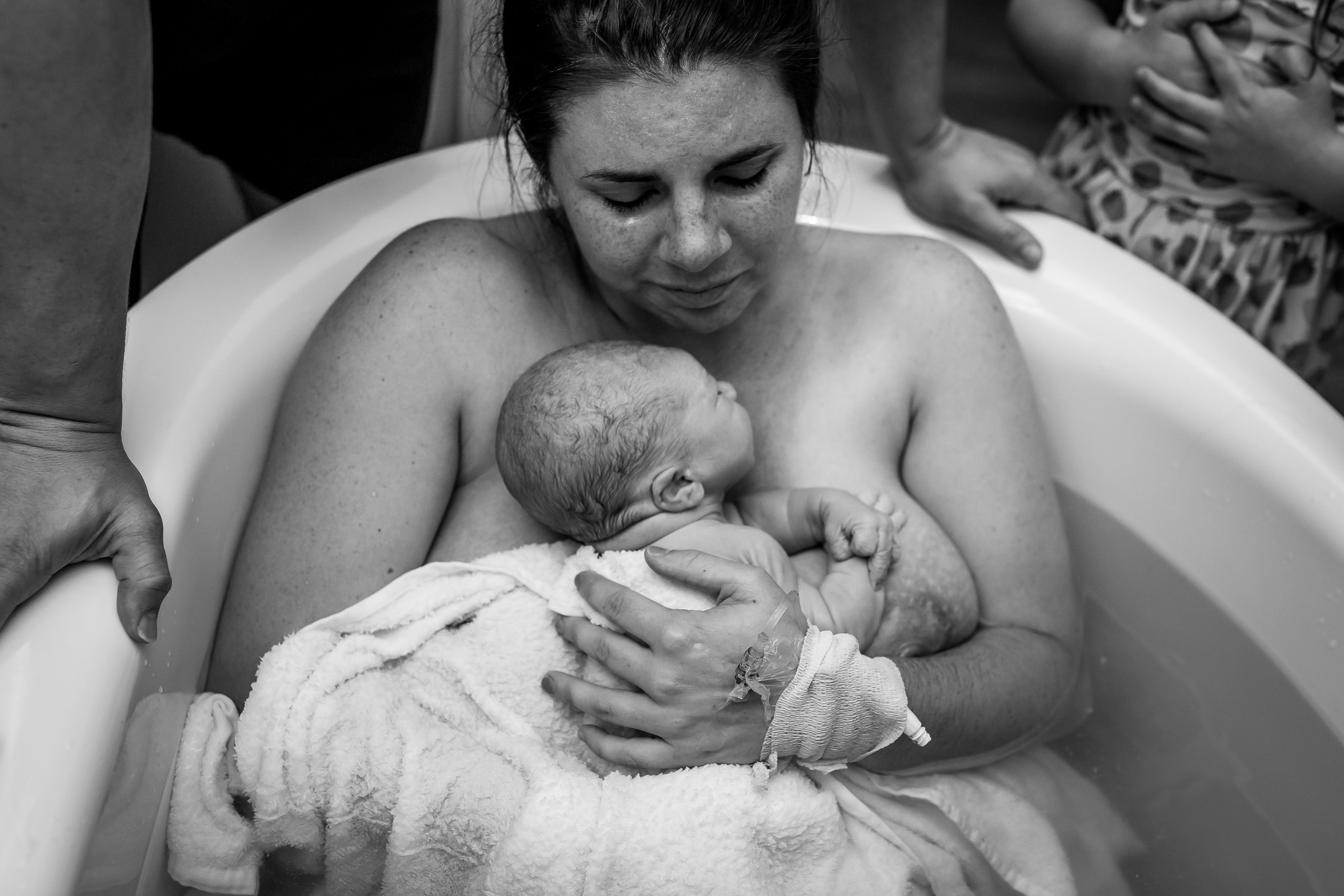 mom hugs baby on her chest after water birth
