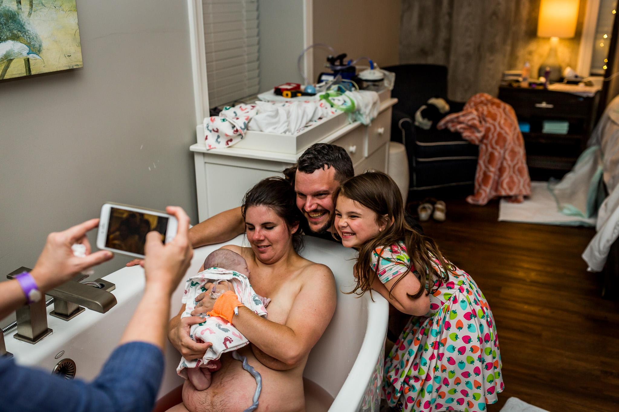 family smiles for picture after water birth