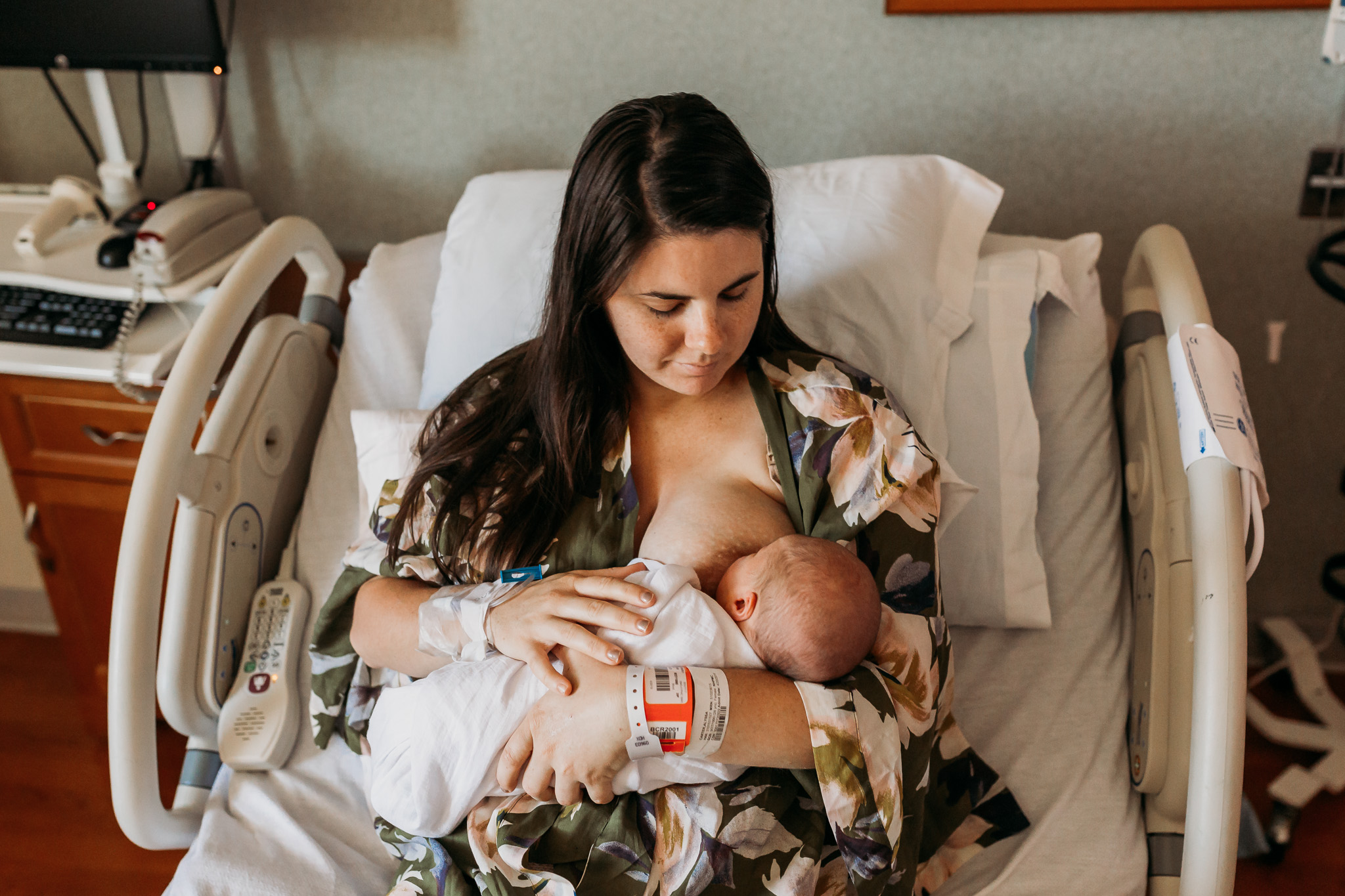 mom in hospital bed breastfeeding son during fresh 48