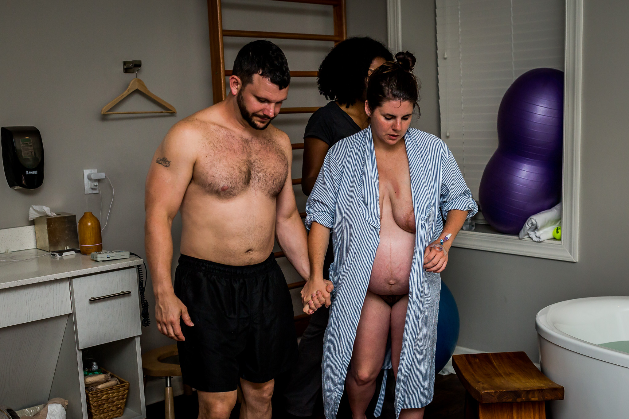 husband walks wife back to bath to birth baby