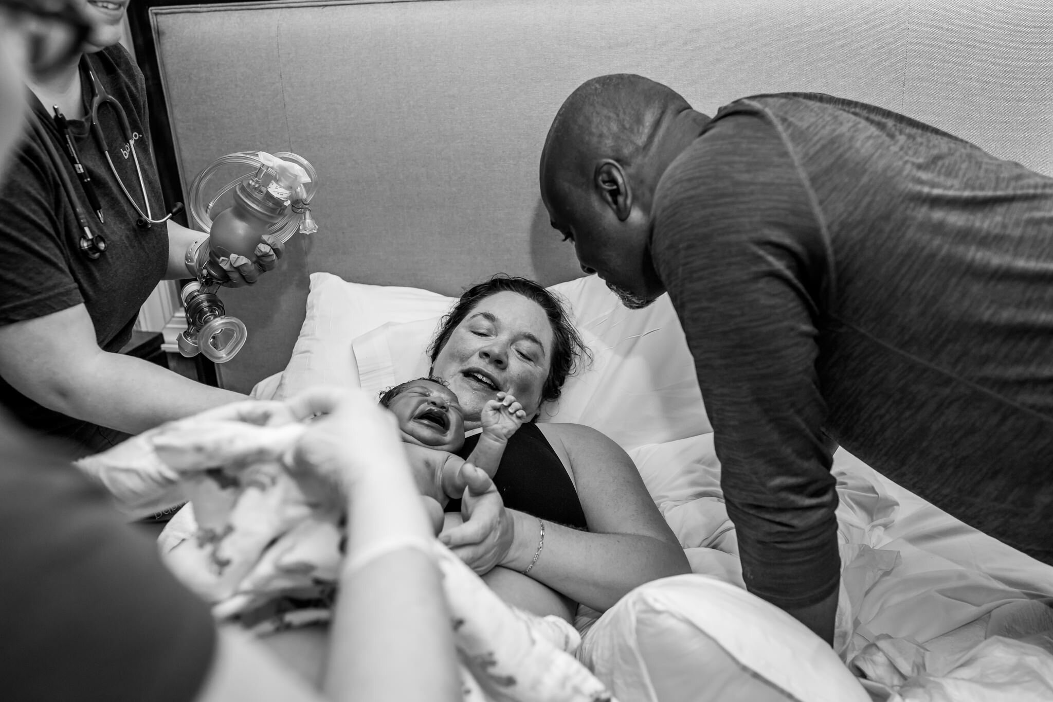 parents look at their newborn birthed at birth center
