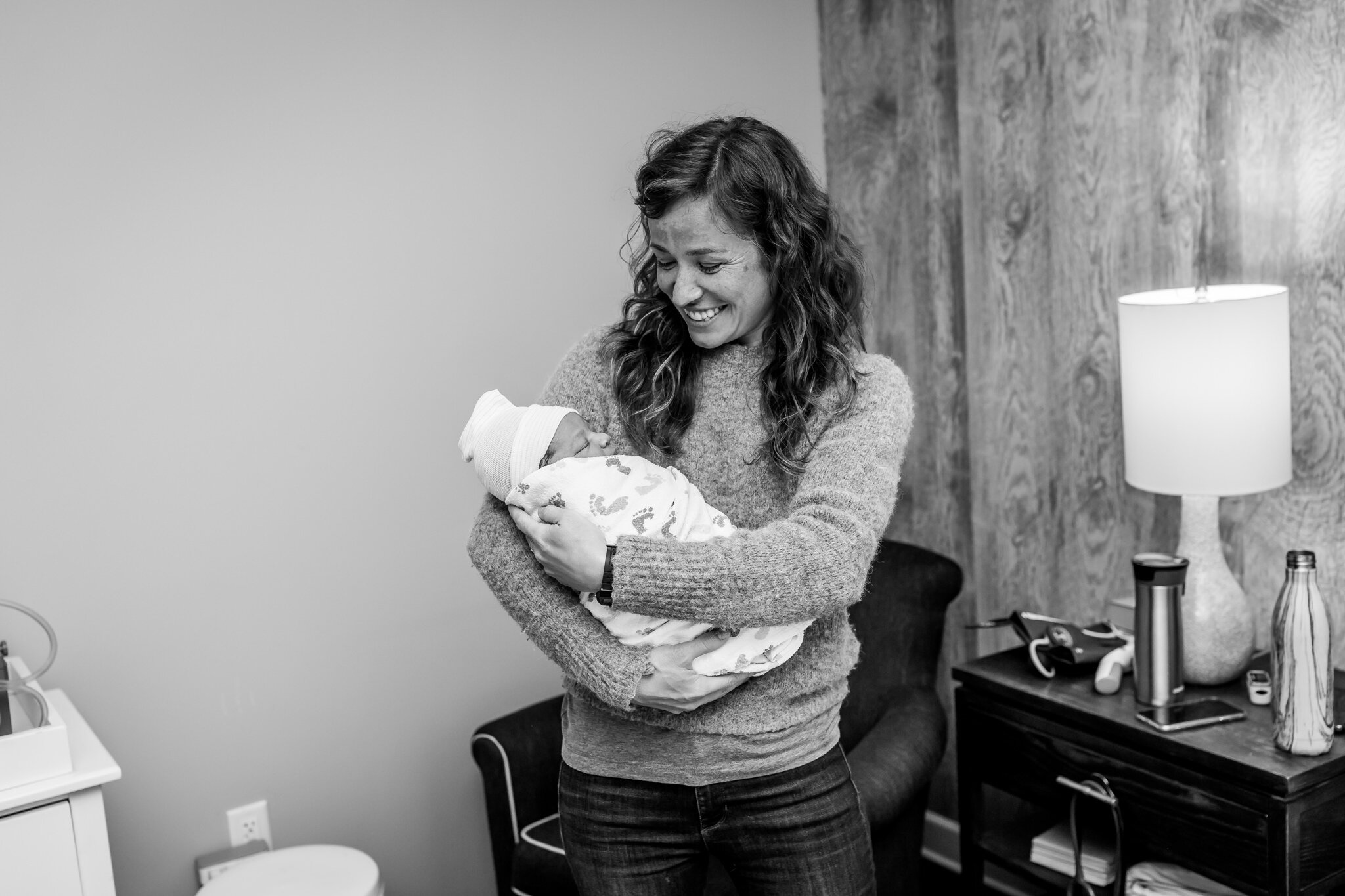 doula holding newborn at birth center birth