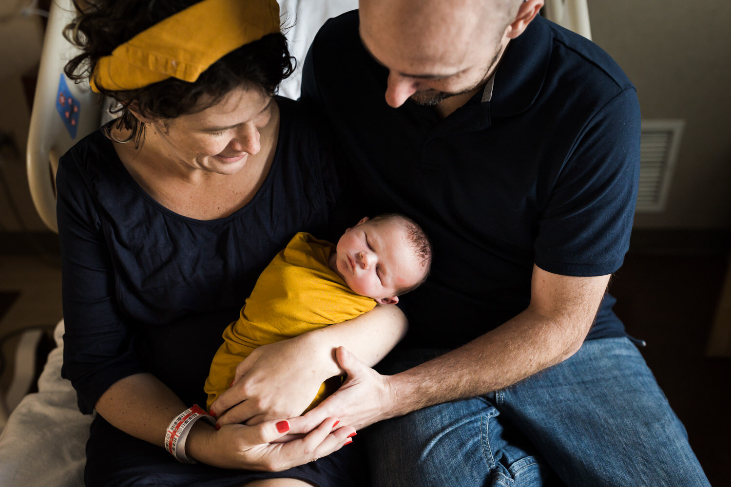 new parents holding newborn during fresh 48