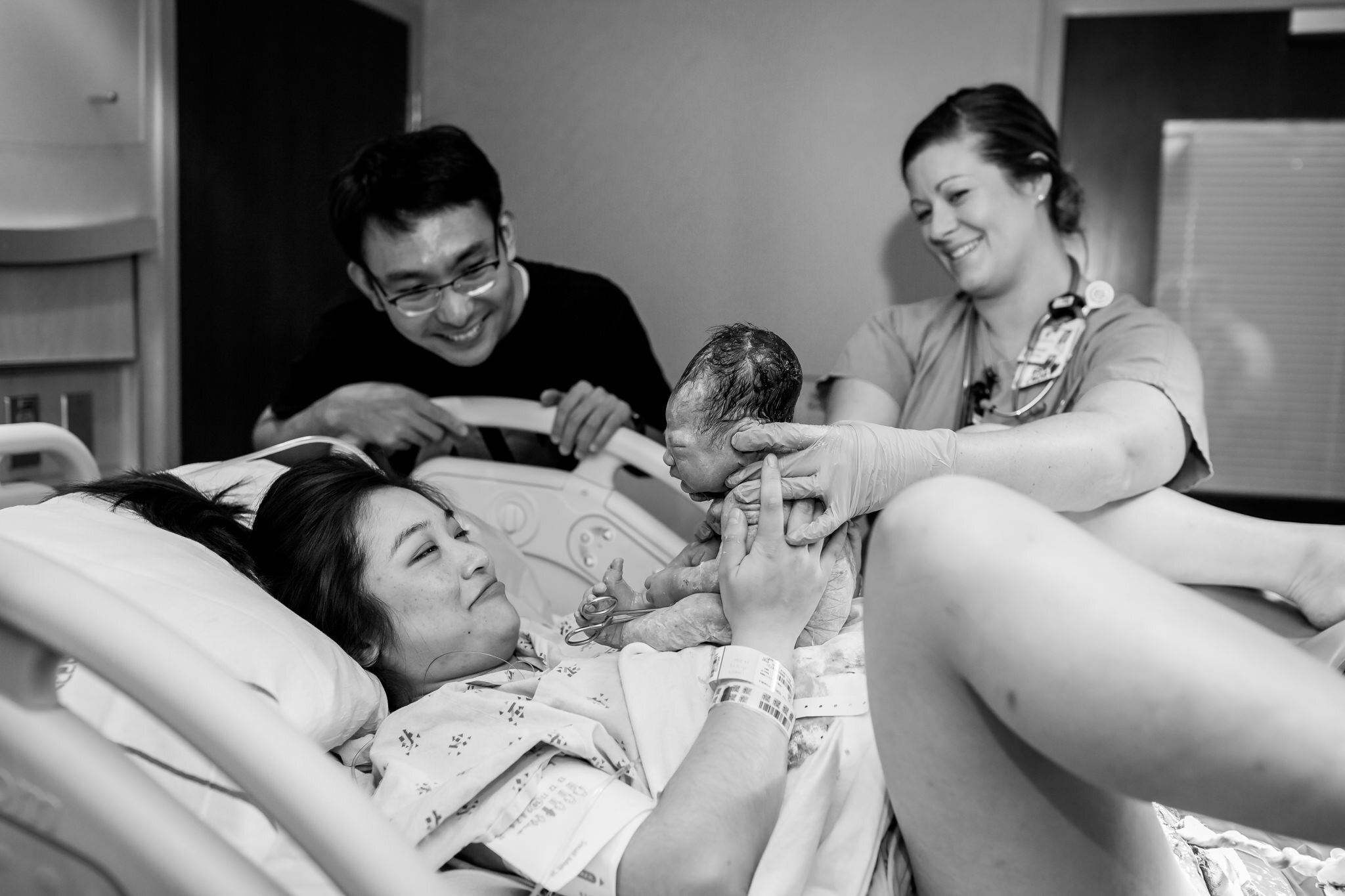 mom looks at newborn son after birth