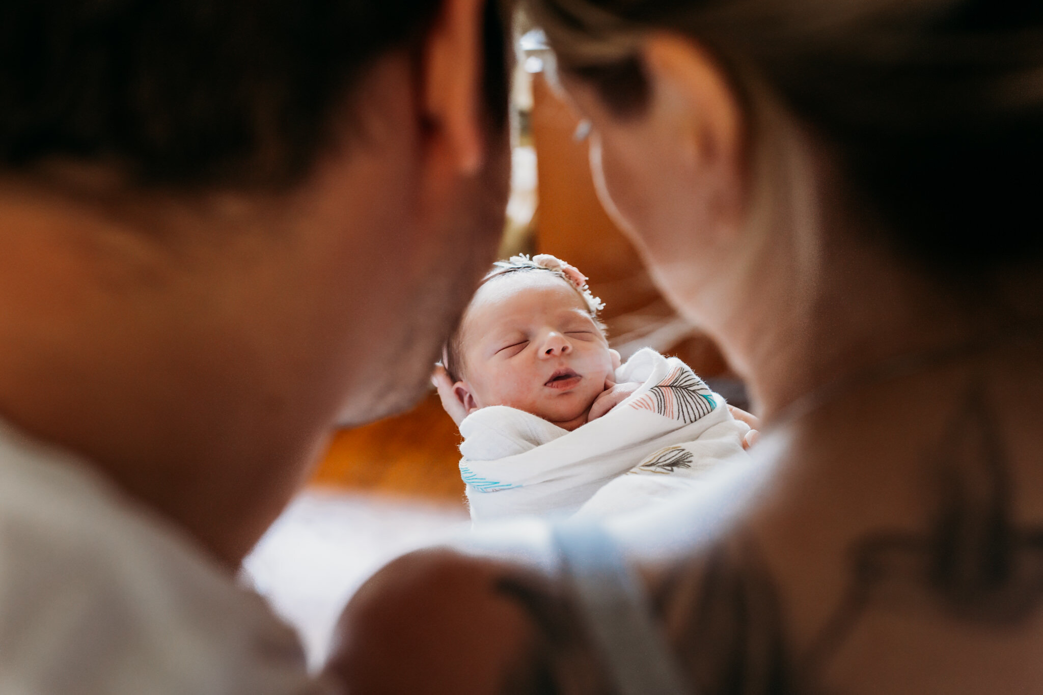 new parents gazing at infant baby fresh 48 hospital session