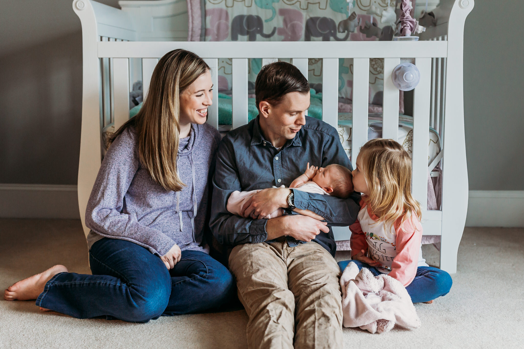 family holding newborn crib lifecycle newborn