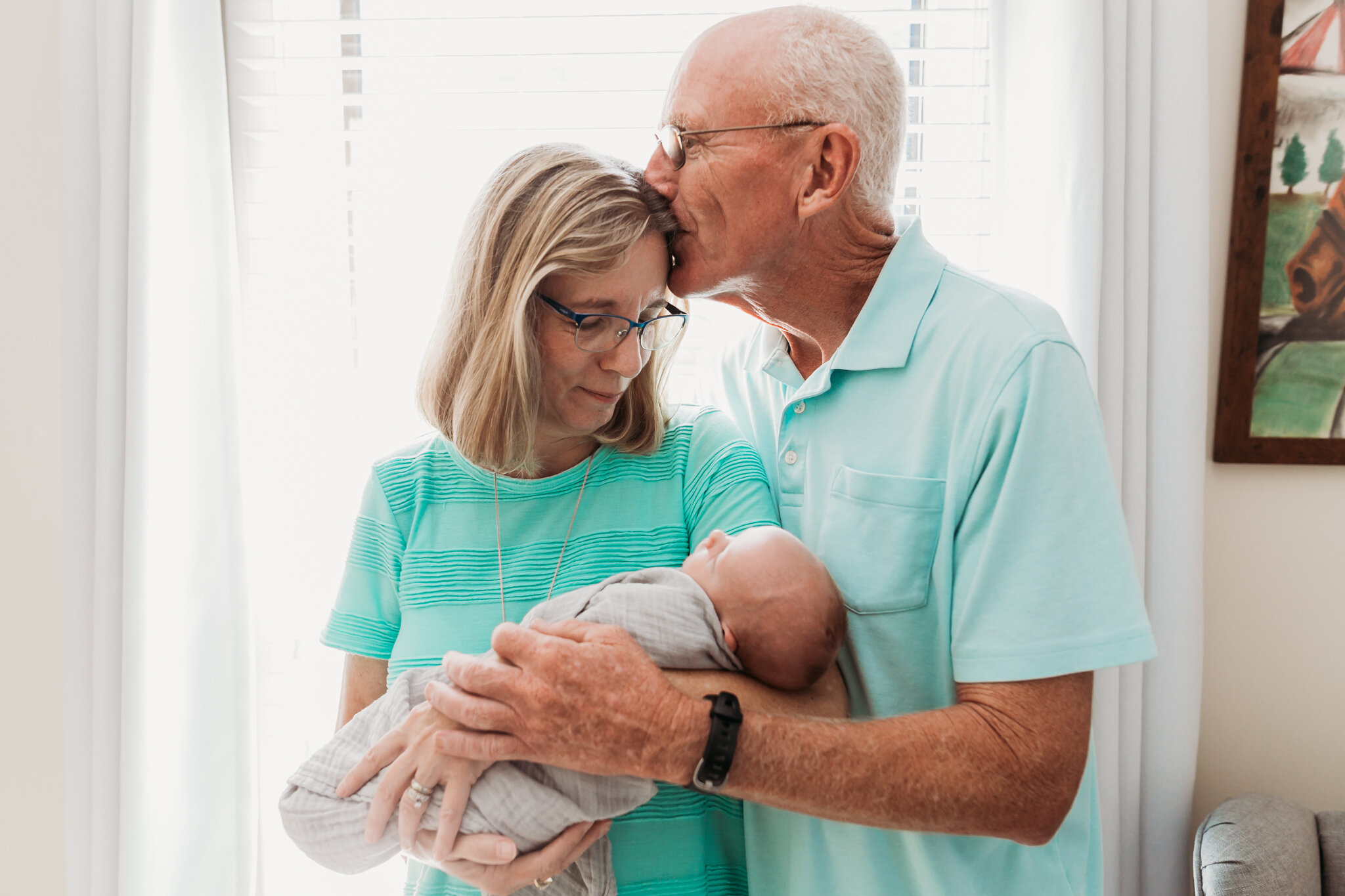 grandparents hold newborn grandbaby lifestyle newborn
