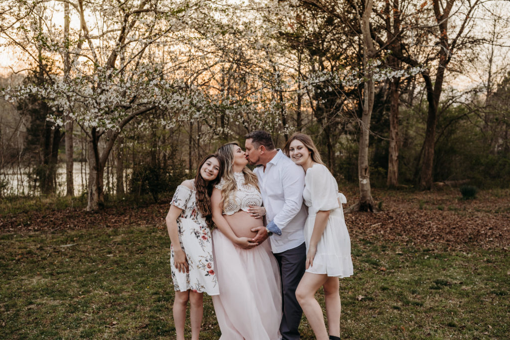 Family of 4 snuggling during maternity session