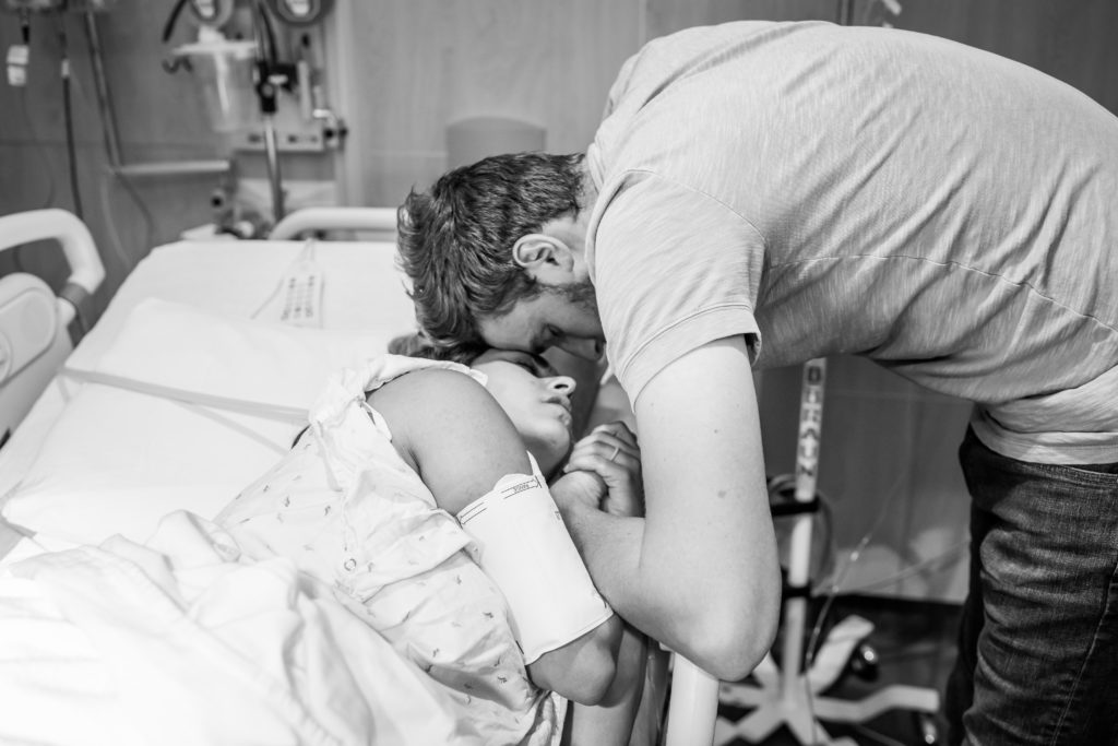 couple embracing during birth labor contraction