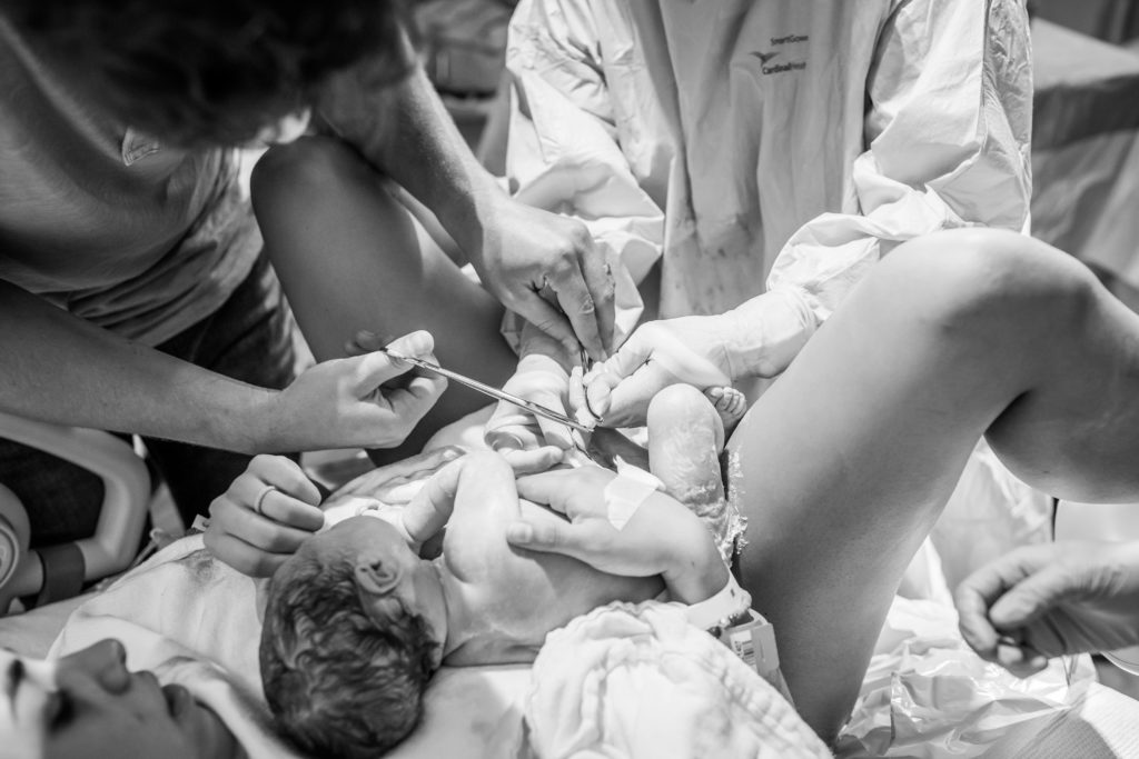 Father cutting umbilical cord after hospital birth