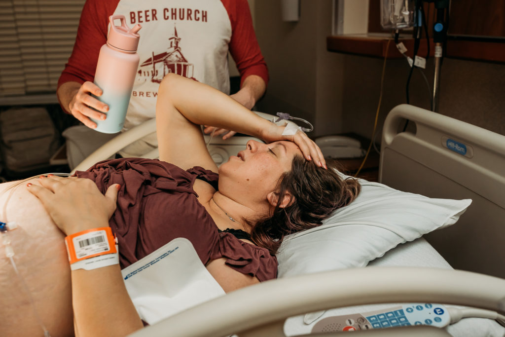 tired mom resting between contractions during birth