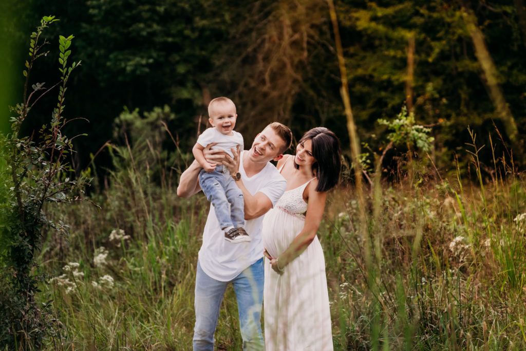 maternity session with parents having fun with toddler son