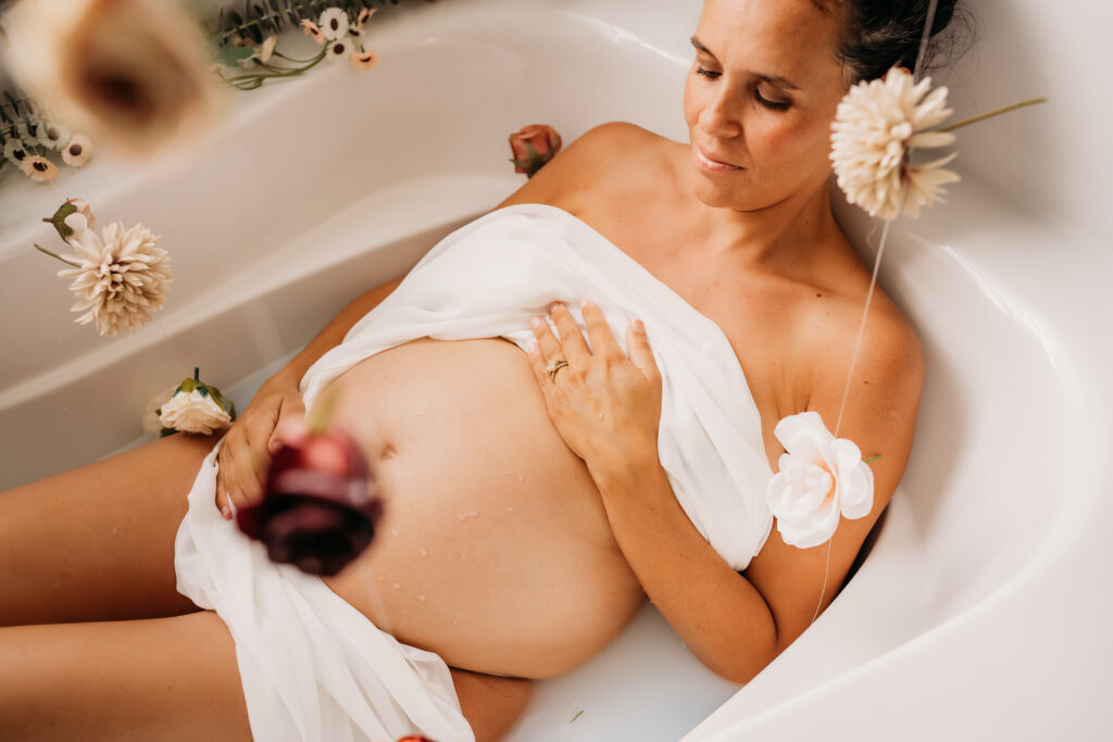 floral maternity milk bath with bare belly