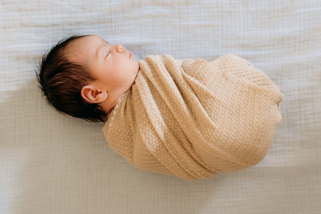 Baby in crib during lifestyle newborn session