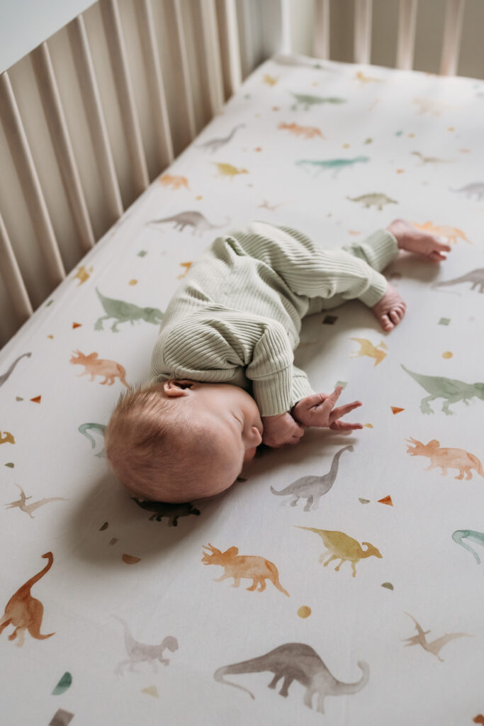 Baby laying in a crib during first week with new baby