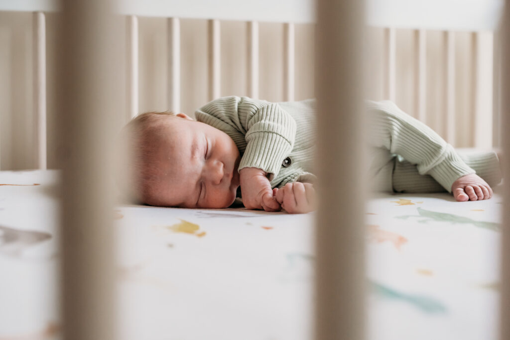Baby laying in a crib during first week with new baby