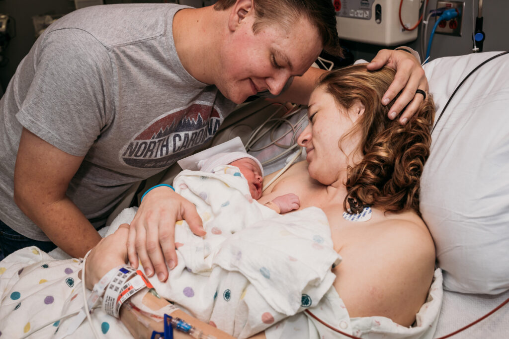 Parents looking at baby after c-section