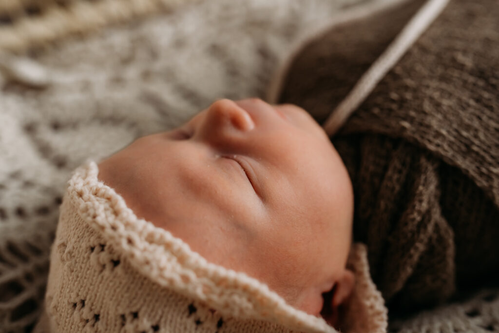 up close of newborn profile in knit bonnet