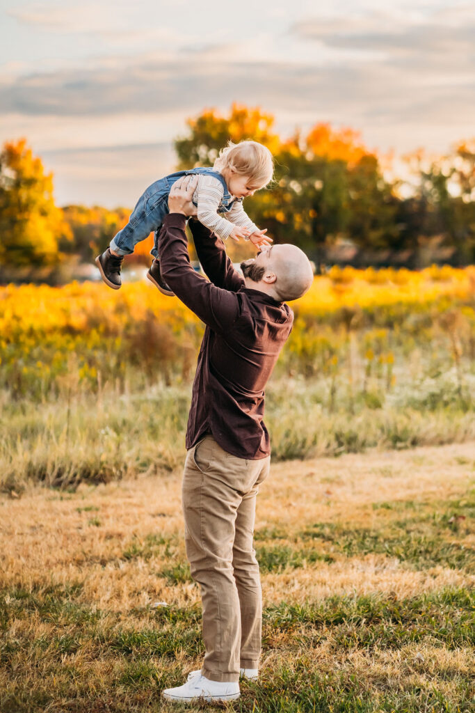 dad lifting son into the air