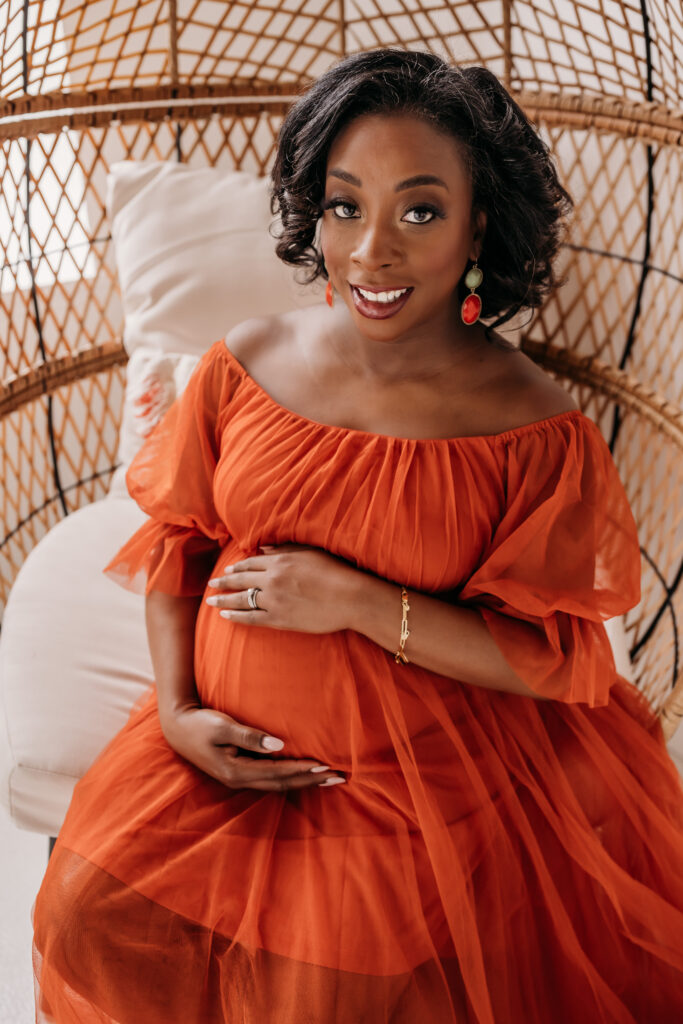 close up of mother in orange tulle dress for maternity pregnancy cravings photoshoot