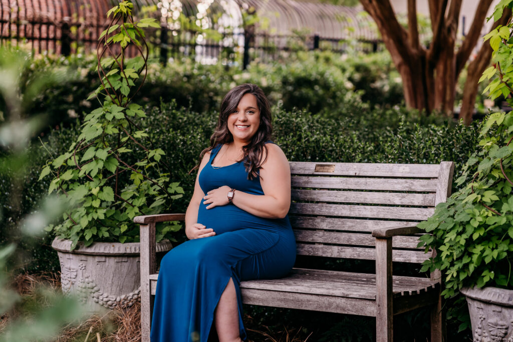 pregnant woman sitting on park bench