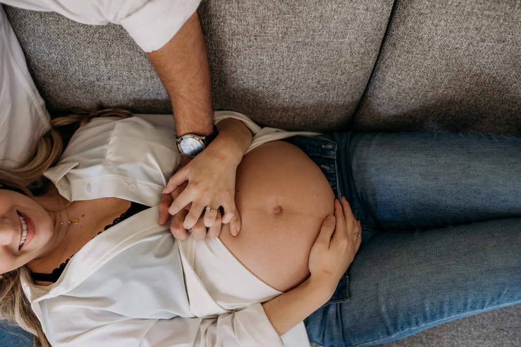 Dad holding hands with mom on the couch